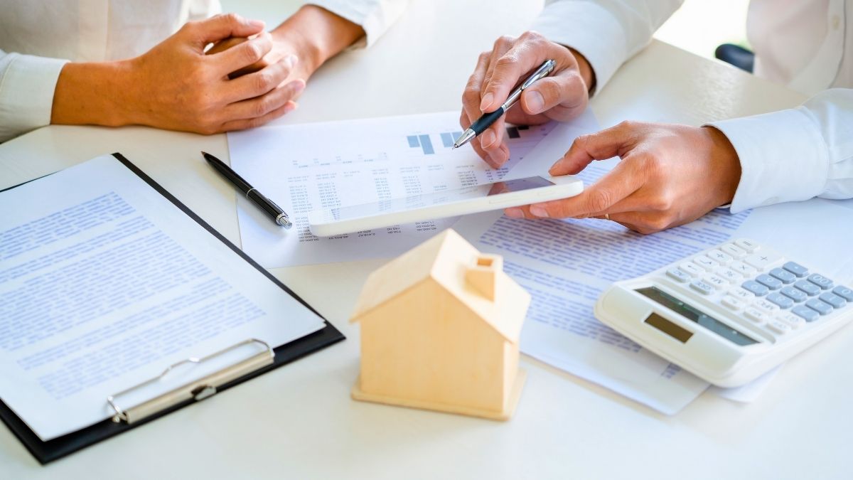 Certified Divorce Real Estate Expert evaluating property valuation documents for a California home sale